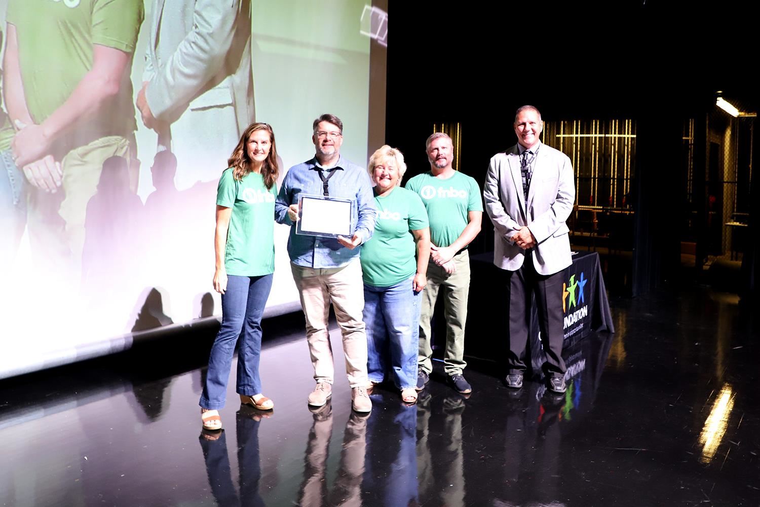 Jesse LaBrie accepting his Teacher of the Year Award on stage at GIPS Welcome Back.